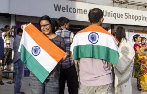 People holding and wearing the Indian national flag during Republic Day celebrations at a public gathering
